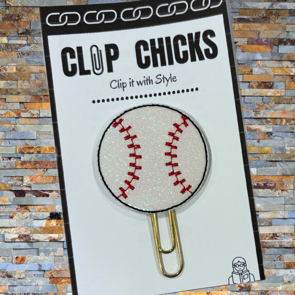 Clip Chicks' Baseball novelty paper clip is shown in its package against a brick wall.