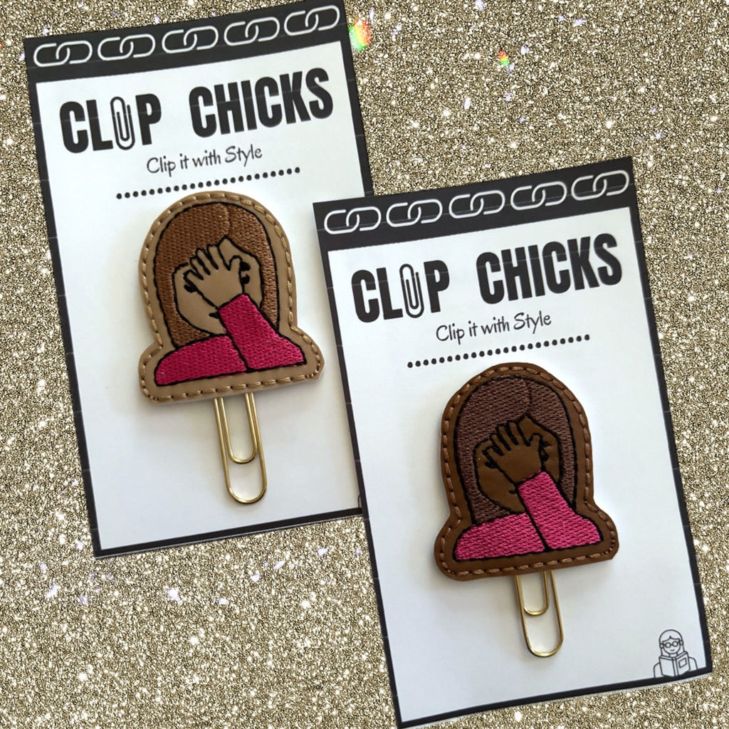 Two Clip Chicks Face-Palm novelty paper clips are shown in their packages.