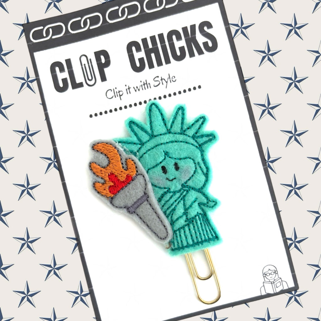 Clip Chicks' Lady Liberty novelty paper clip is shown in its packaging. Great for gifting, as a reading and writing incentive, and a fun paper organizer.