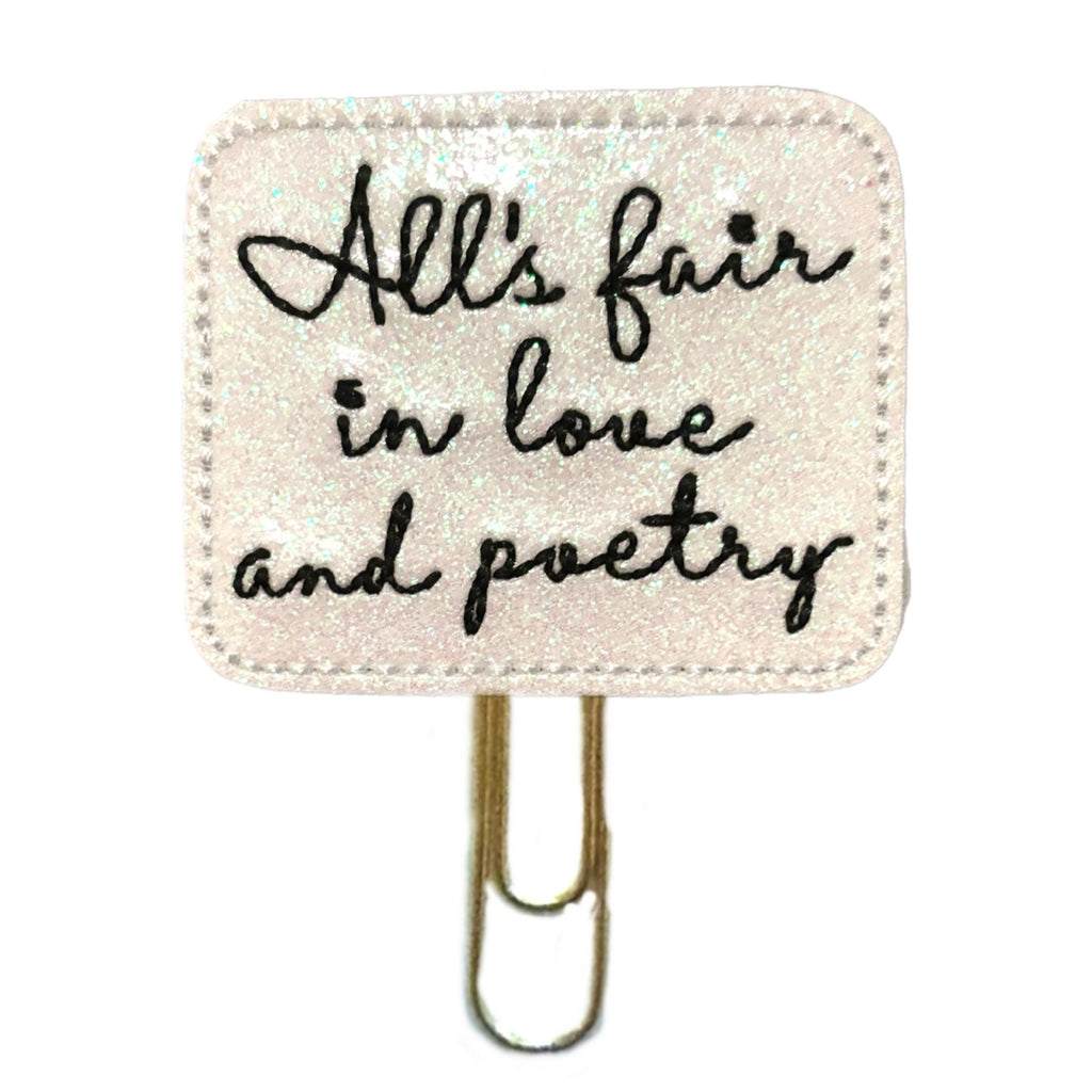 Taylor Swift inspired novelty paper clip that has "All's Fair in Love and Poetry" embroidered on it.