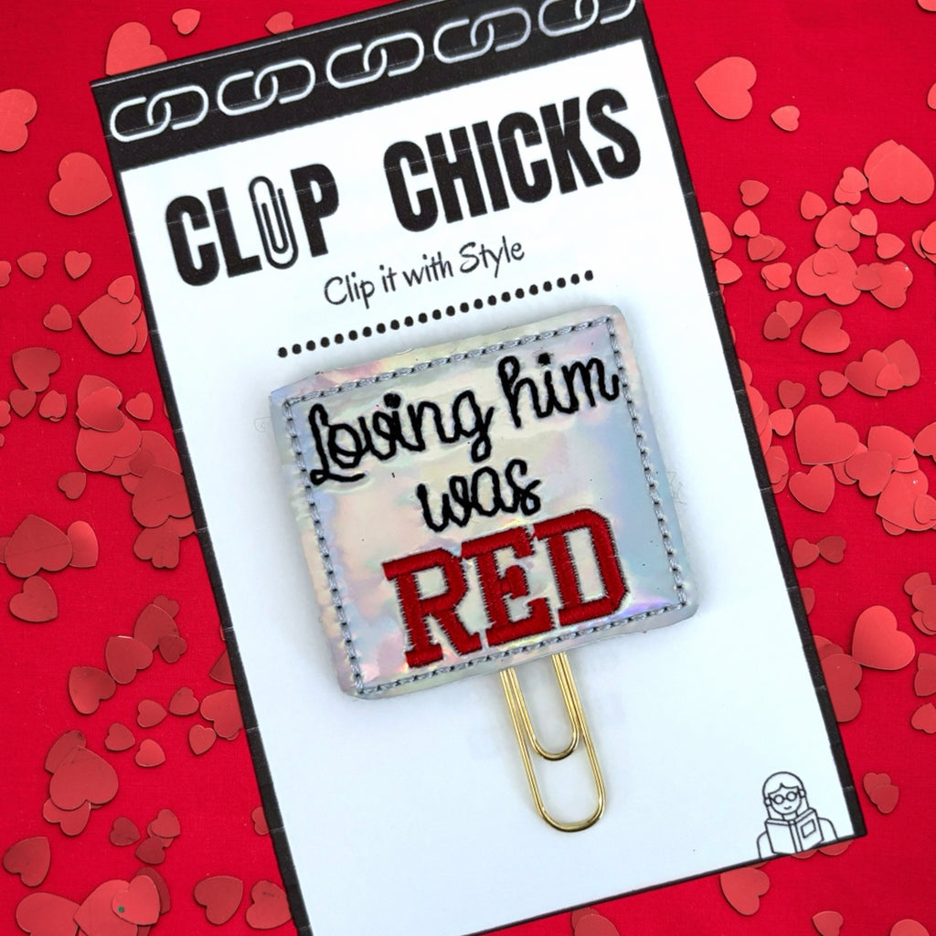 Loving Him was red novelty paper clip from Clip Chicks is shown in its package against a red backdrop.