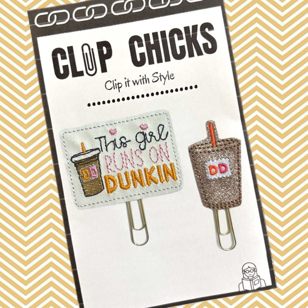The set of 2 This Girl Runs on Dunkin novelty paper clips from Clip Chicks LLC are shown in the package.