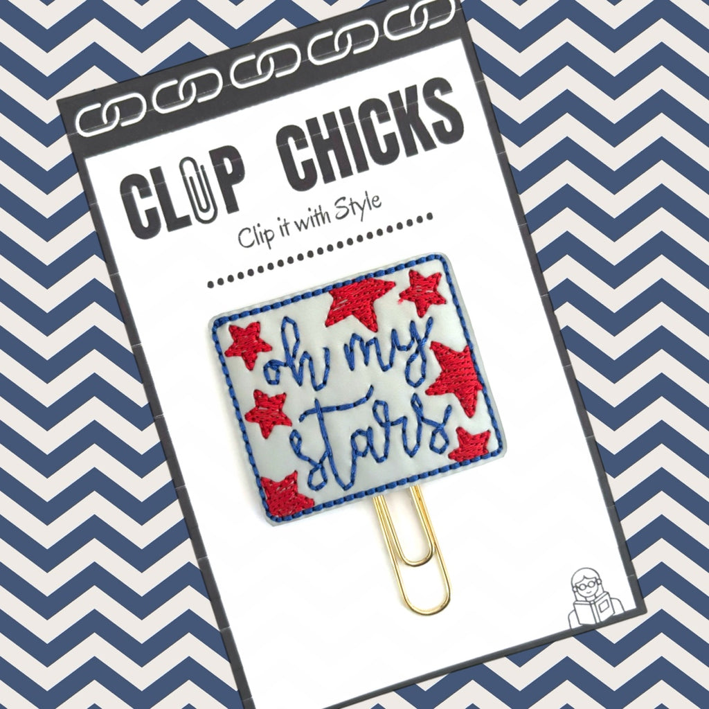 Oh My Stars novelty paper clip from Clip Chicks is shown in its package against a blue and white chevron background.