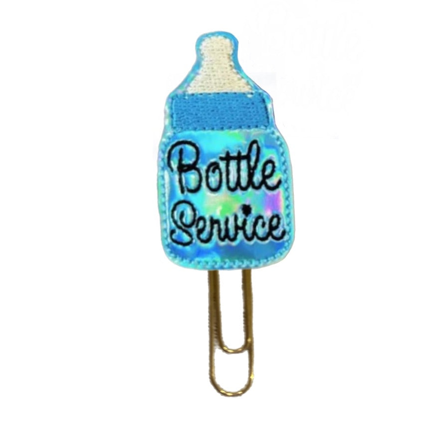 Bottle Service novelty paper clip from Clip Chicks is a cute bookmark or planner clip that is shaped like a blue bottle. The embroidered bottle is attached to a planner clip.