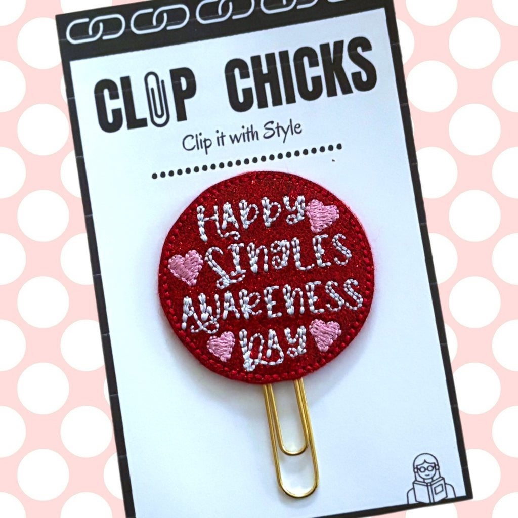 Clip Chicks' Singles Awareness Day paper clip is shown in its package against a pink and white polka dot background.