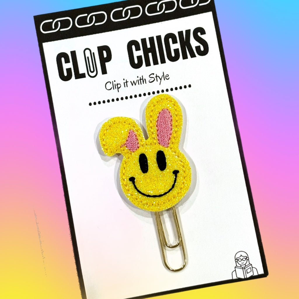 Clip chicks' Easter themed Happy Face with Bunny Ears novelty paper clip is pictured in its adorable packaging and ready for your Easter gift giving.