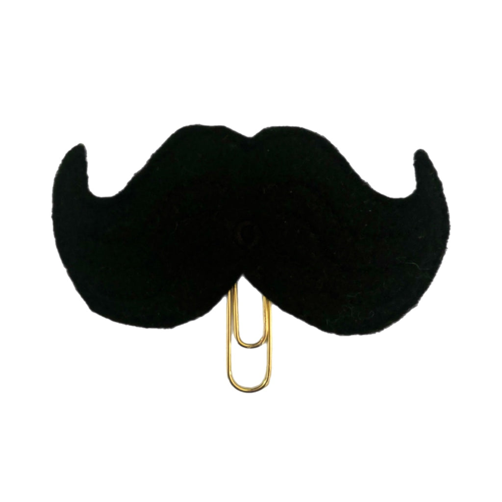 Black mustache novelty paper clip from Clip Chicks, made from top quality black felt attached to a gold toned paper clip. Fun page marker and gift giving item.