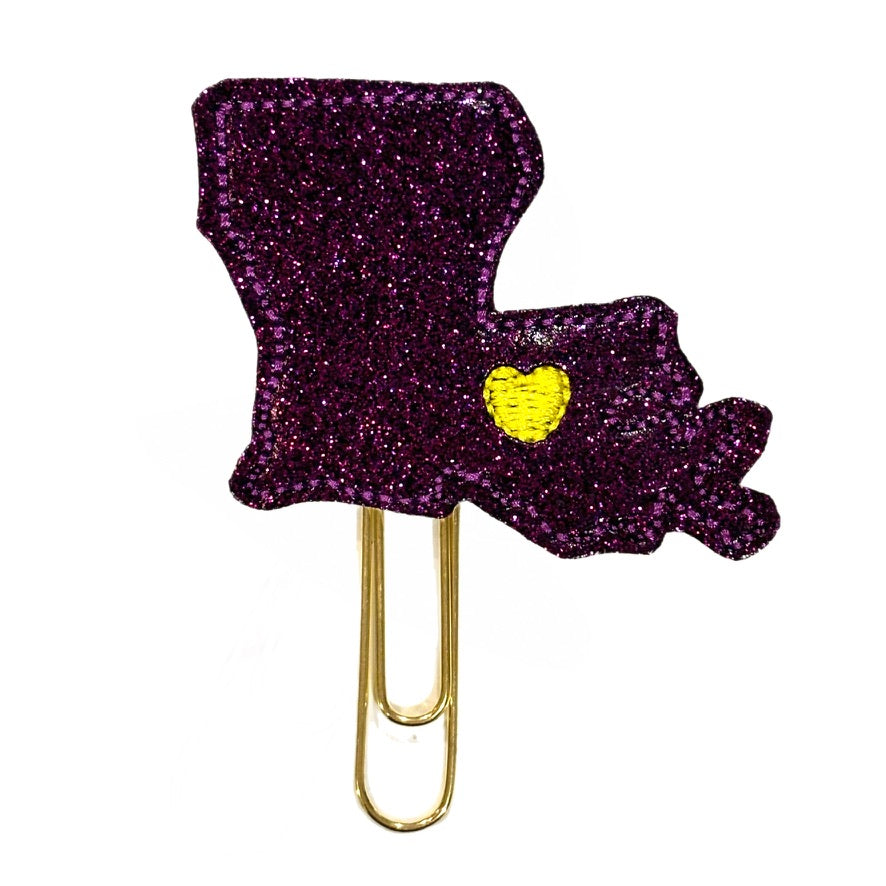 New Orleans Love paper clip is a shimmery purple shaped like Louisiana with a yellow heart embroidered to make new Orleans.