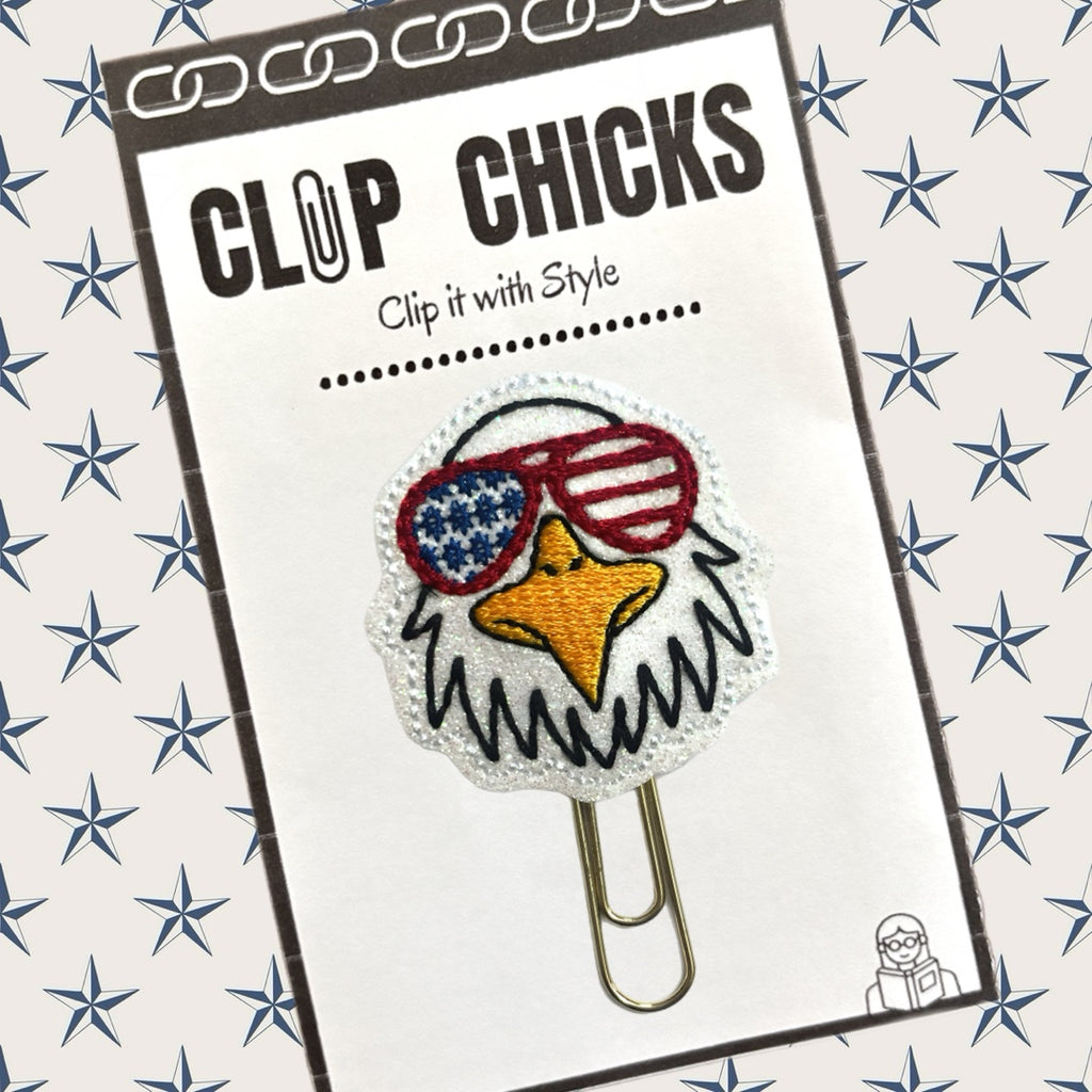 Patriotic Eagle novelty paper/clip planner clip from Clip Chicks is shown in its package against a blue and white star background.