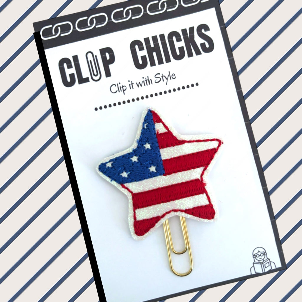 Clip Chicks' Red, White and Blue Star paper clip is shown in its packaging on a blue and white striped background.