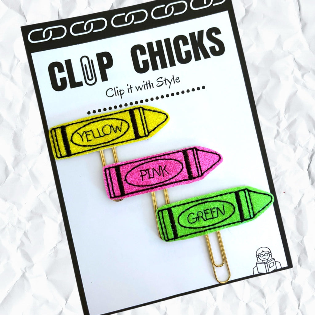 Clip Chicks' Crayon Trio set of three novelty paper clips make up this set that is shown in its package, sitting atop a crumbled piece of white paper.