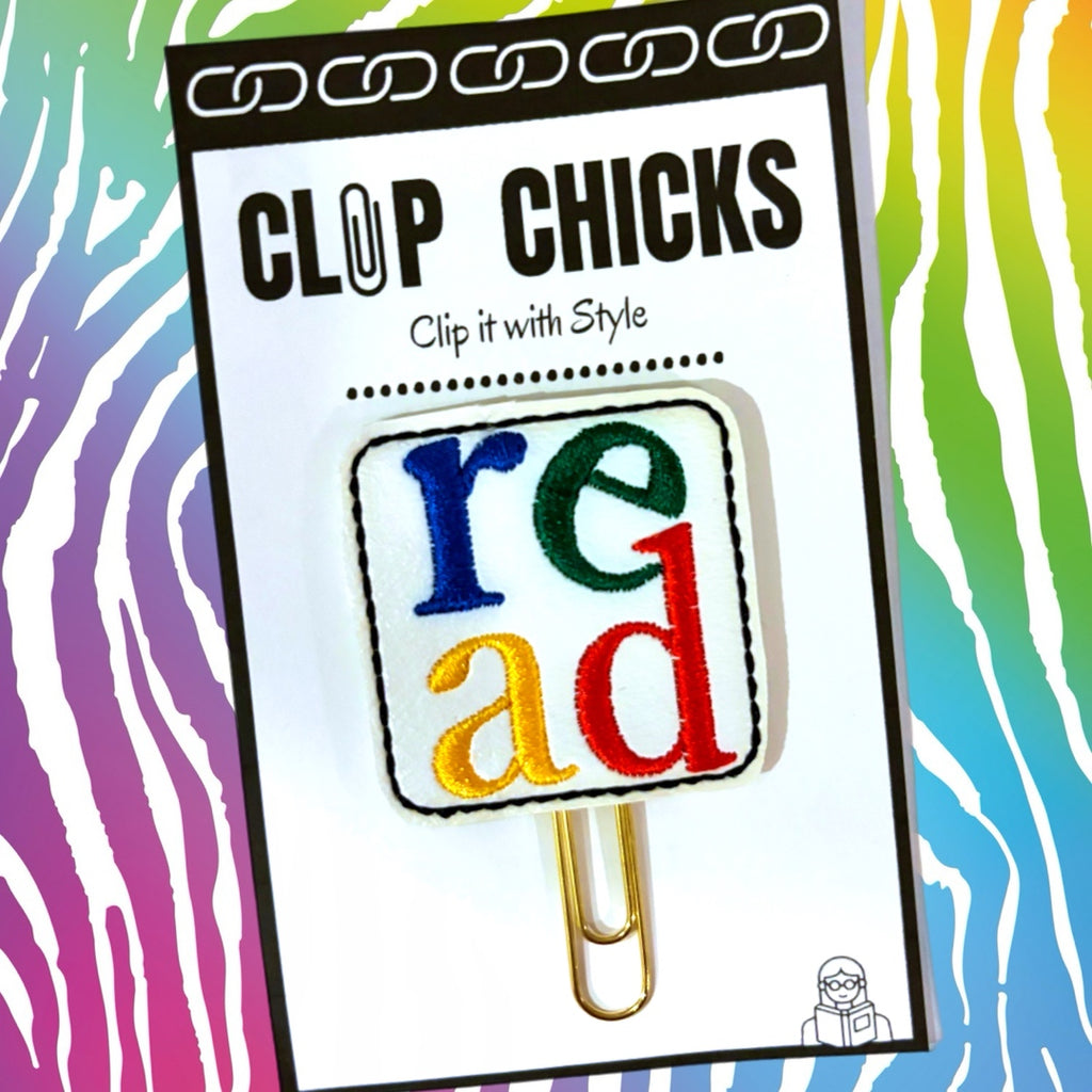 Clip Chicks' READ novelty paper clip is shown in its package against a colorful background.