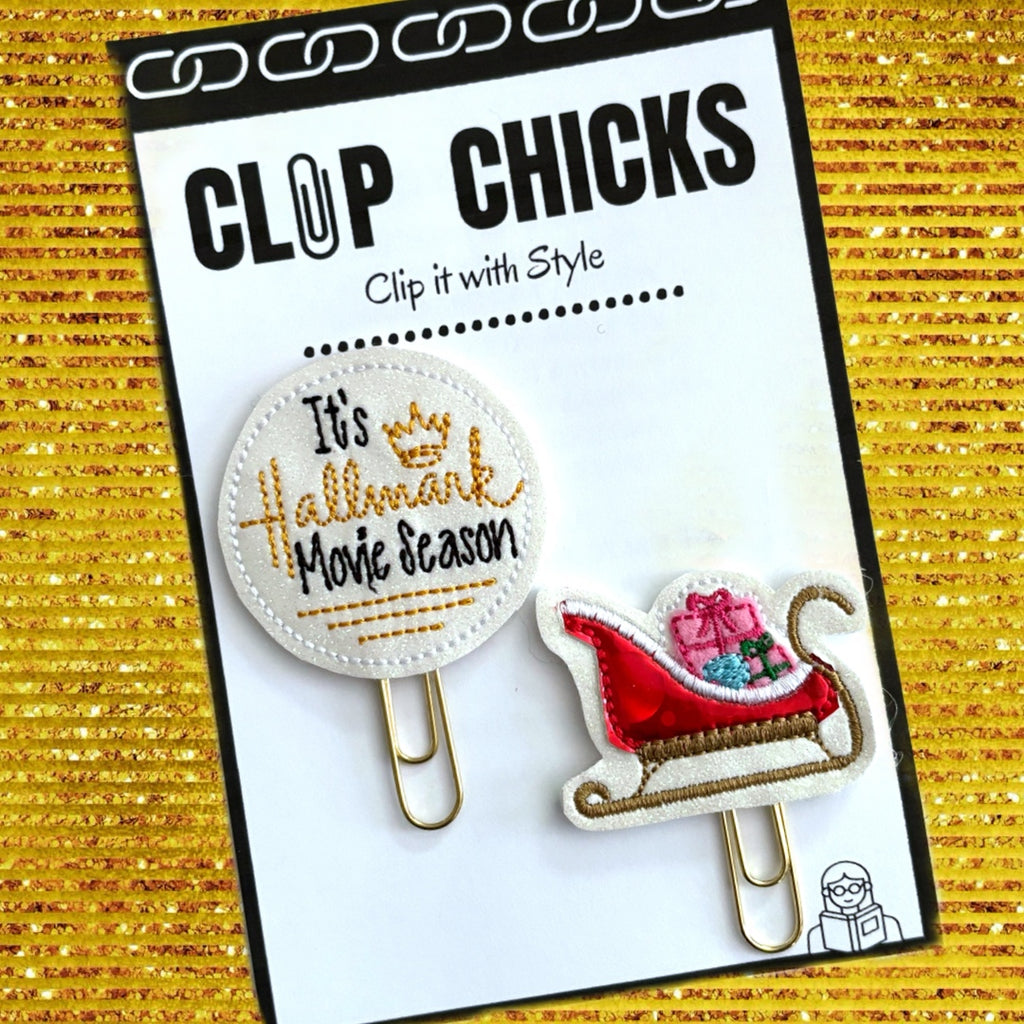 Clip Chicks' Hallmark Movie season and Sleigh set of novelty paper clips are shown in their package.