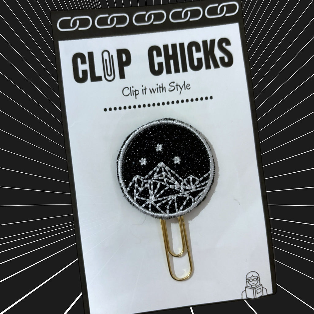 Clip Chicks' ACOTAR-inspired novelty paper clip is shown in its packaging, against a black and white background.