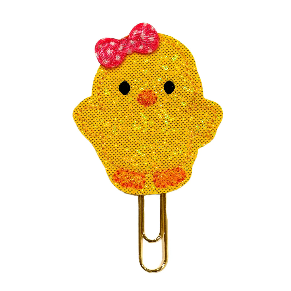 A Clip Chicks novelty paper clip shaped like a chick with a bow on her head.