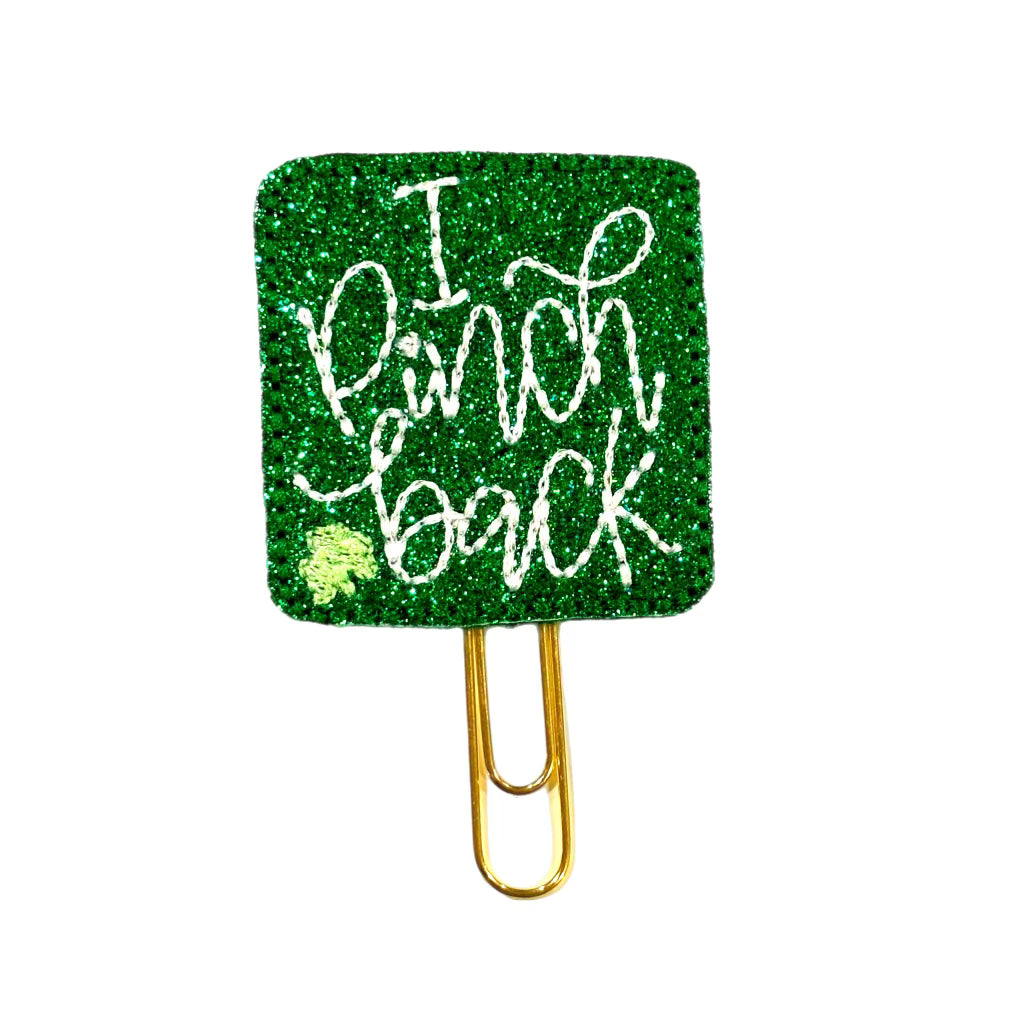 A Clip Chicks novelty paper clip that is attached to a green shimmery  feltie that has I Pinch Back embroidered on it.