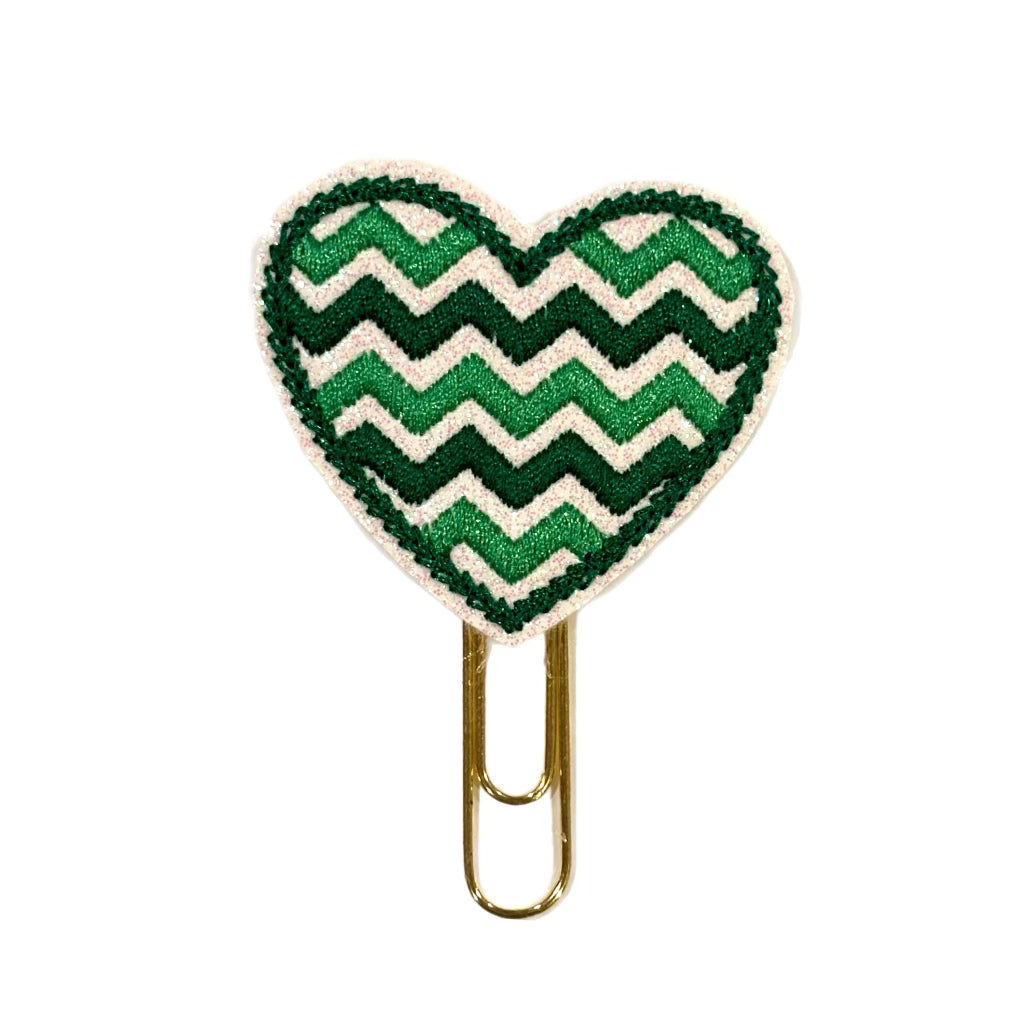 A Clip Chicks novelty paper clip shaped like a heart with chevron green lines embroidered on.