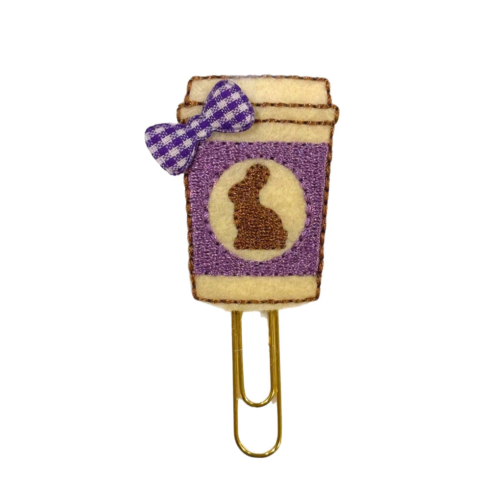 A Clip Chicks novelty paper clip shaped like a coffee cup with a bunny and bow on it.