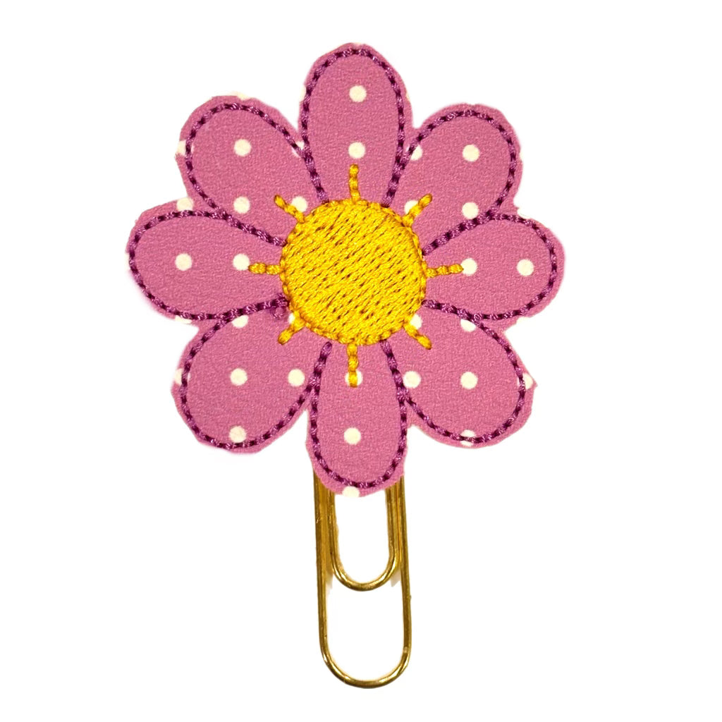 A Clip Chicks novelty paper clip that is shaped like a daisy.