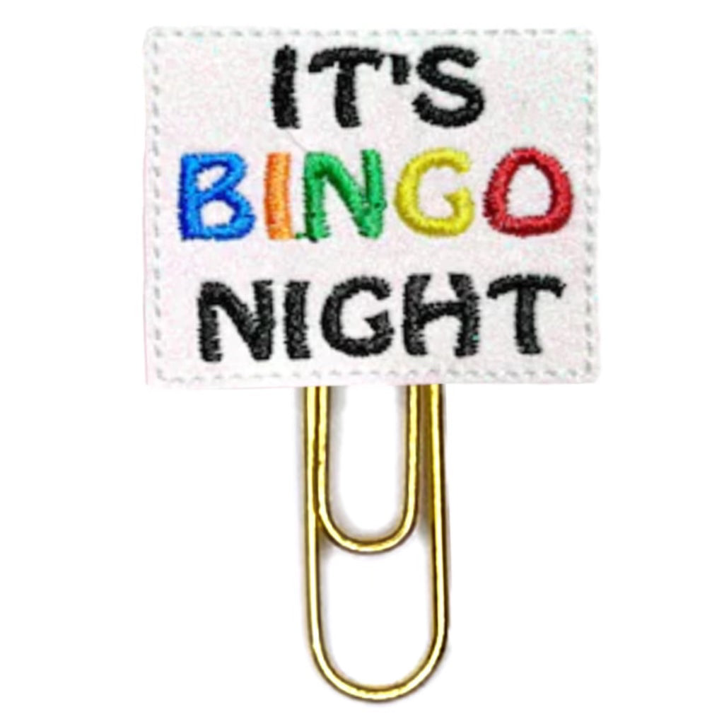 It's Bingo Night is embroidered onto a rectangular pice of white shimmery felt in colorful thread and attached to a paper clip.