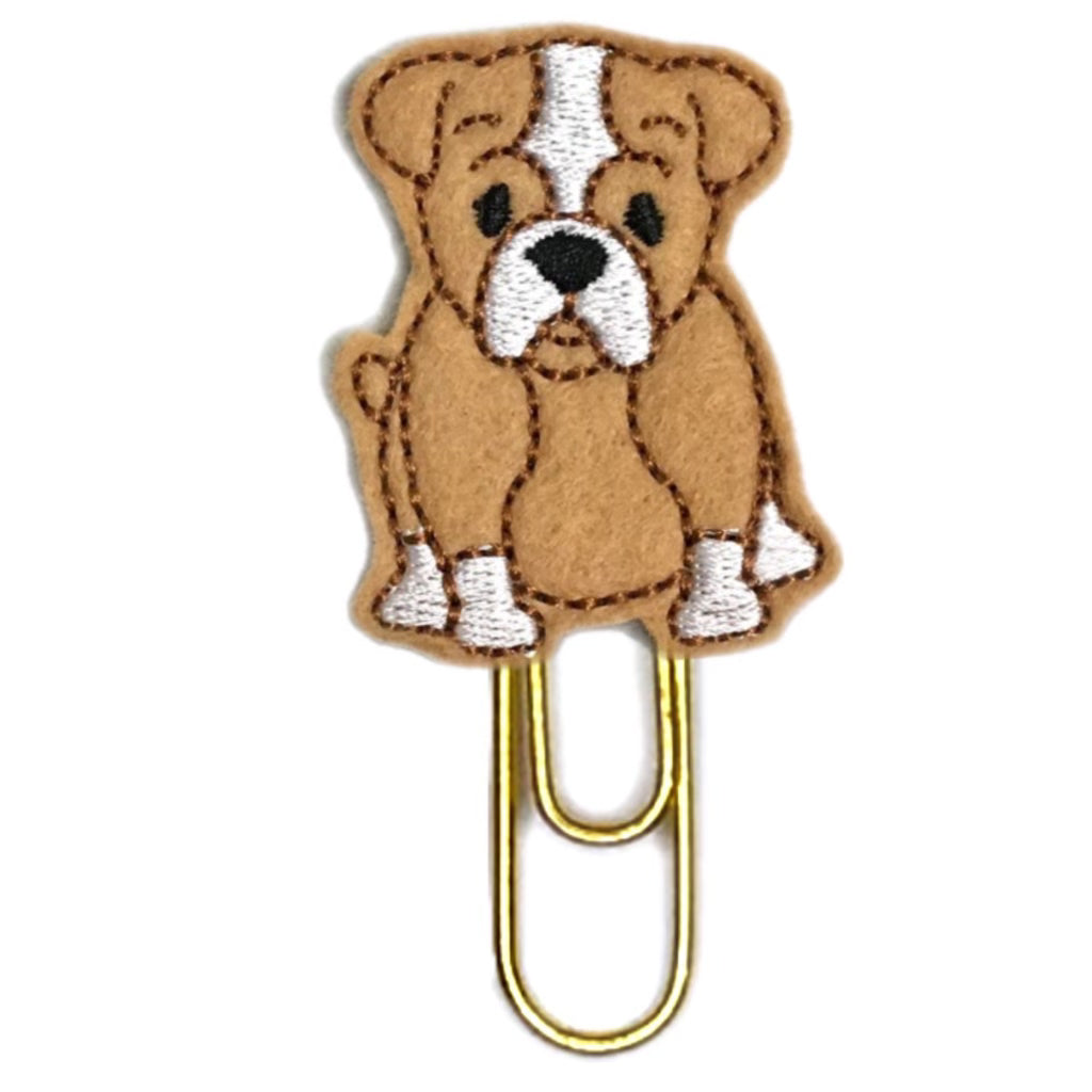 Bulldog novelty paper clip is beige felt embroidered and shaped like a bulldog and attached to a paper clip.