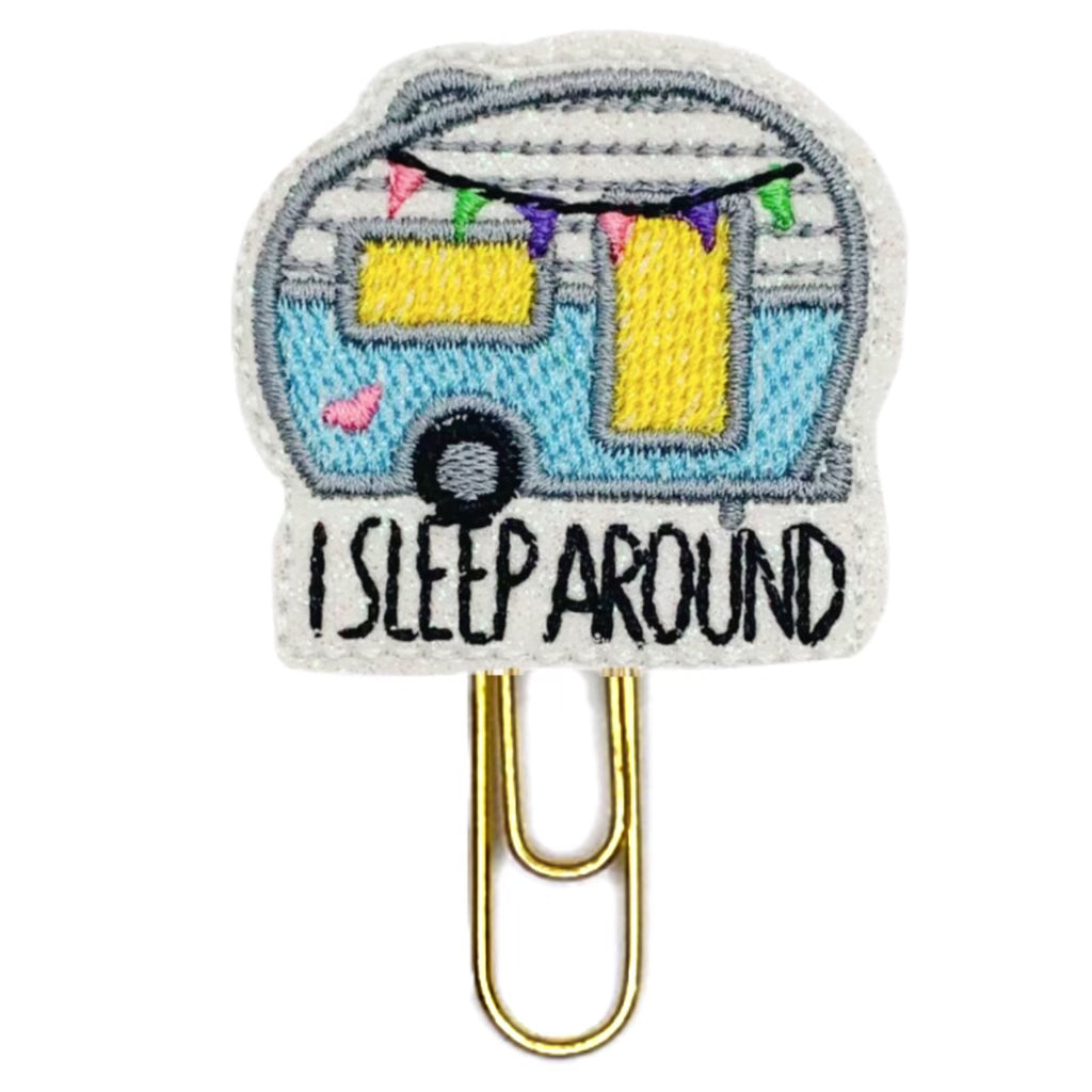 I Sleep Around novelty paper clip from Clip Chicks, shows a camper embroidered with bright colors.