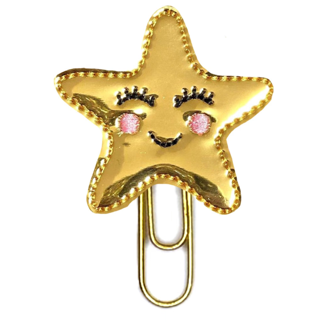 A shiny Gold Star novelty paper clip is shown from Clip Chicks LLC.