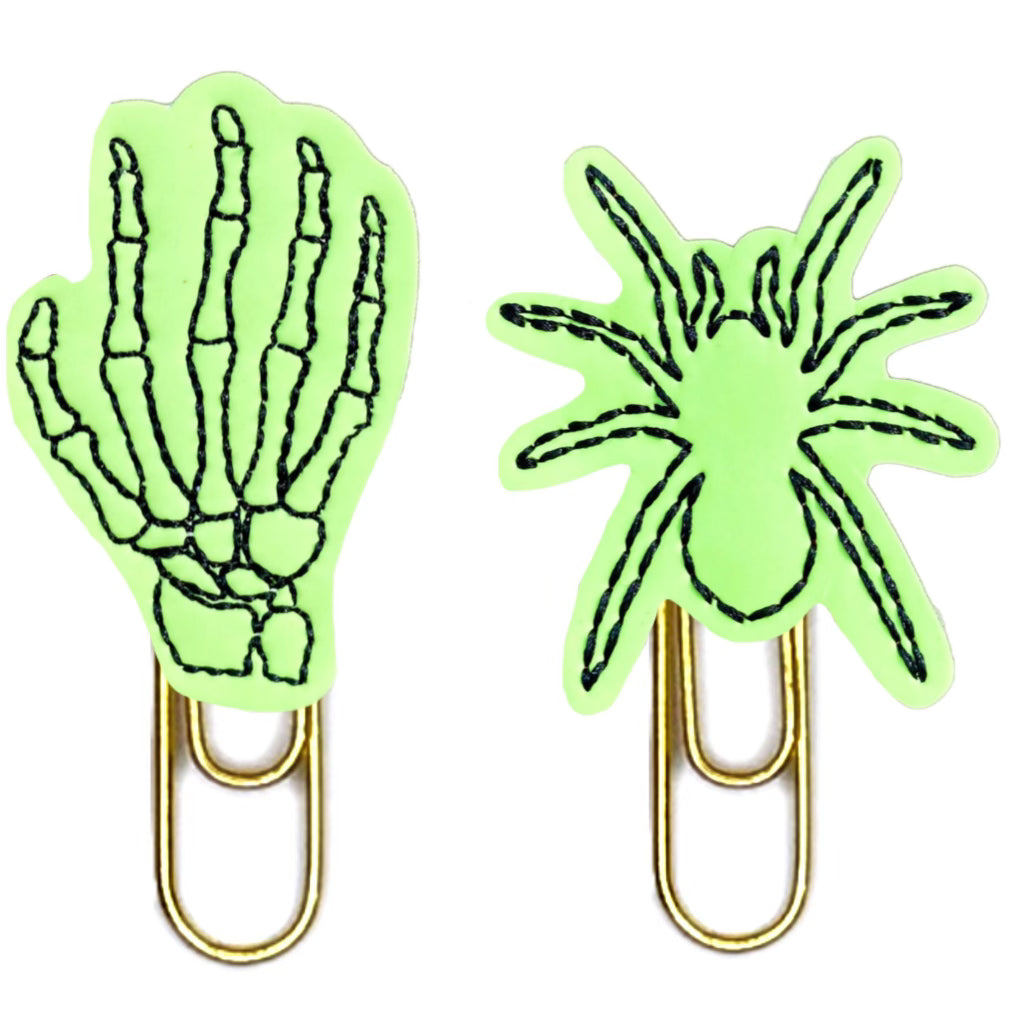 Glow in the dark set of spooky Halloween novelty paper clips. One spider and on skeleton hand make up the set.