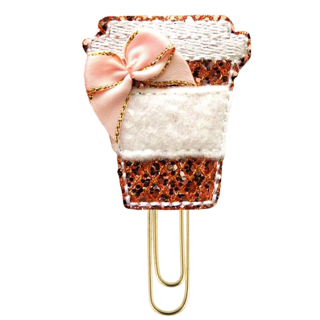 Glittery Coffee Cup novelty paper clip is shimmery pink with white felt and a pink bow and is attached with a paper clip.