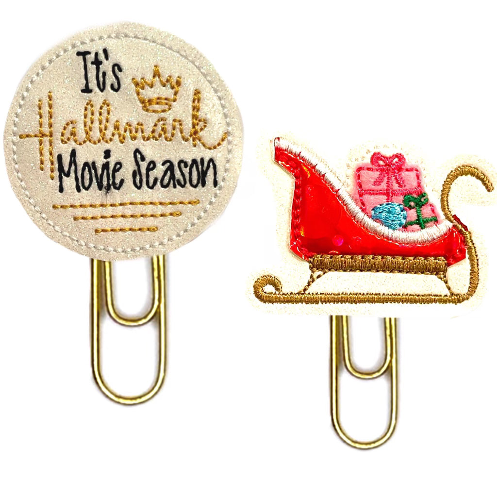 It's Hallmark season and Red Sleigh novelty paper clips are shown against a white background.