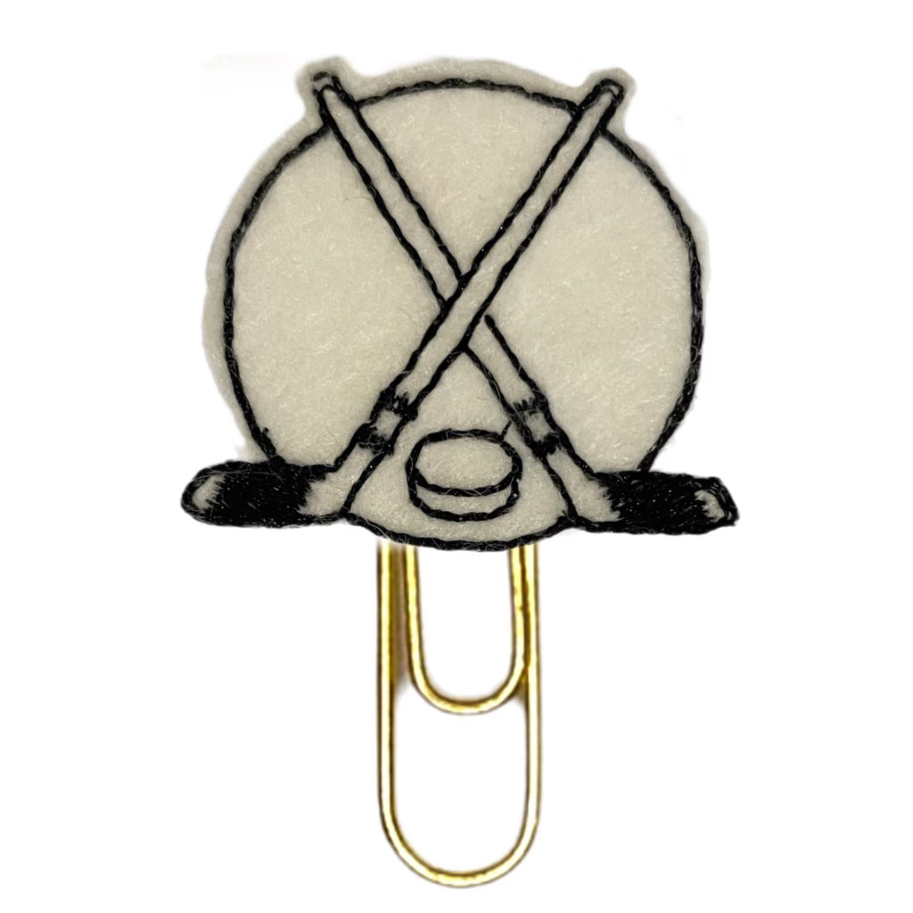 Hockey themed novelty paper clip from Clip Chicks is white with black embroidery.