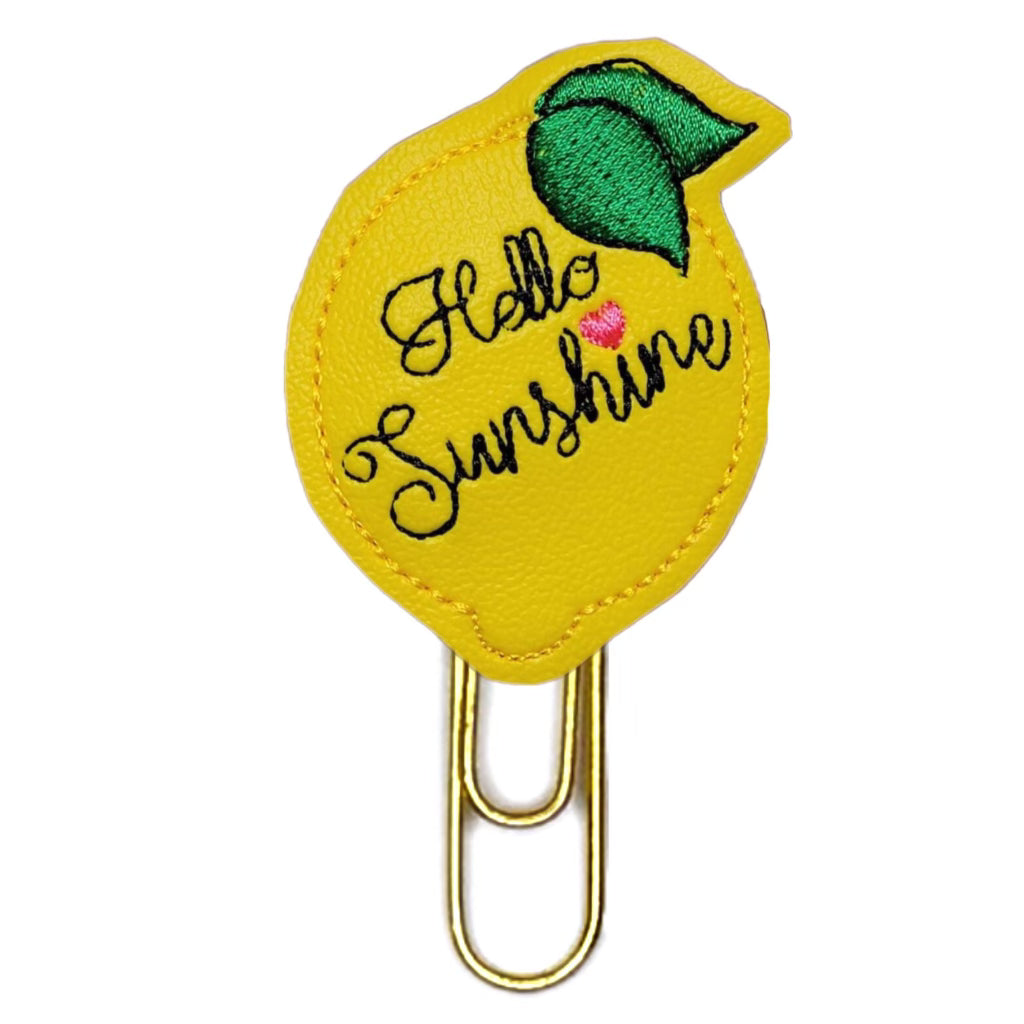 Hello Sunshine novelty paper clip from Clip Chicks is shaped like a lemon with Hello Sunshine embroidered on it.