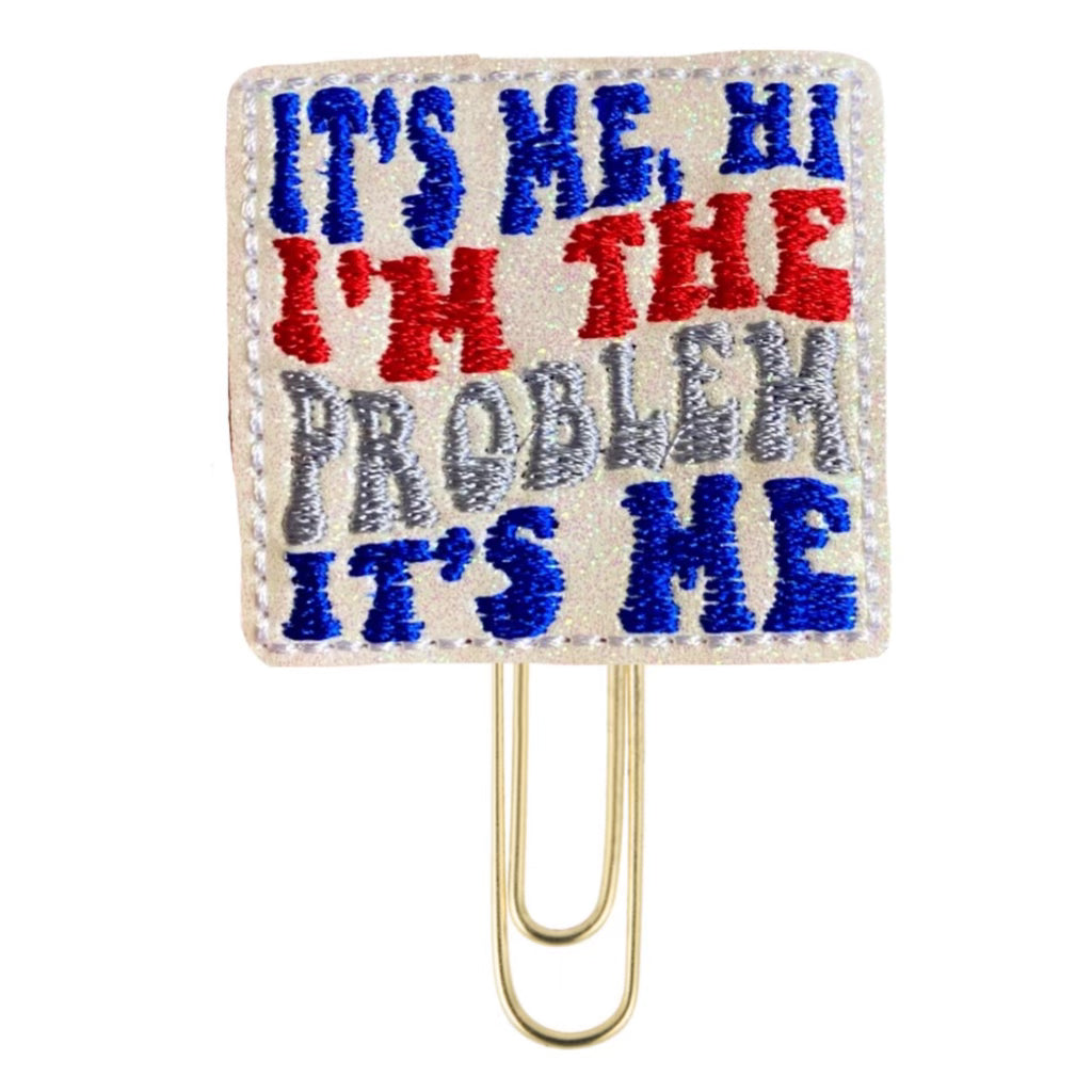 It's Me, Hi I'm the Problem It's Me, is embroidered on a novelty paper clip from Clip Chicks.