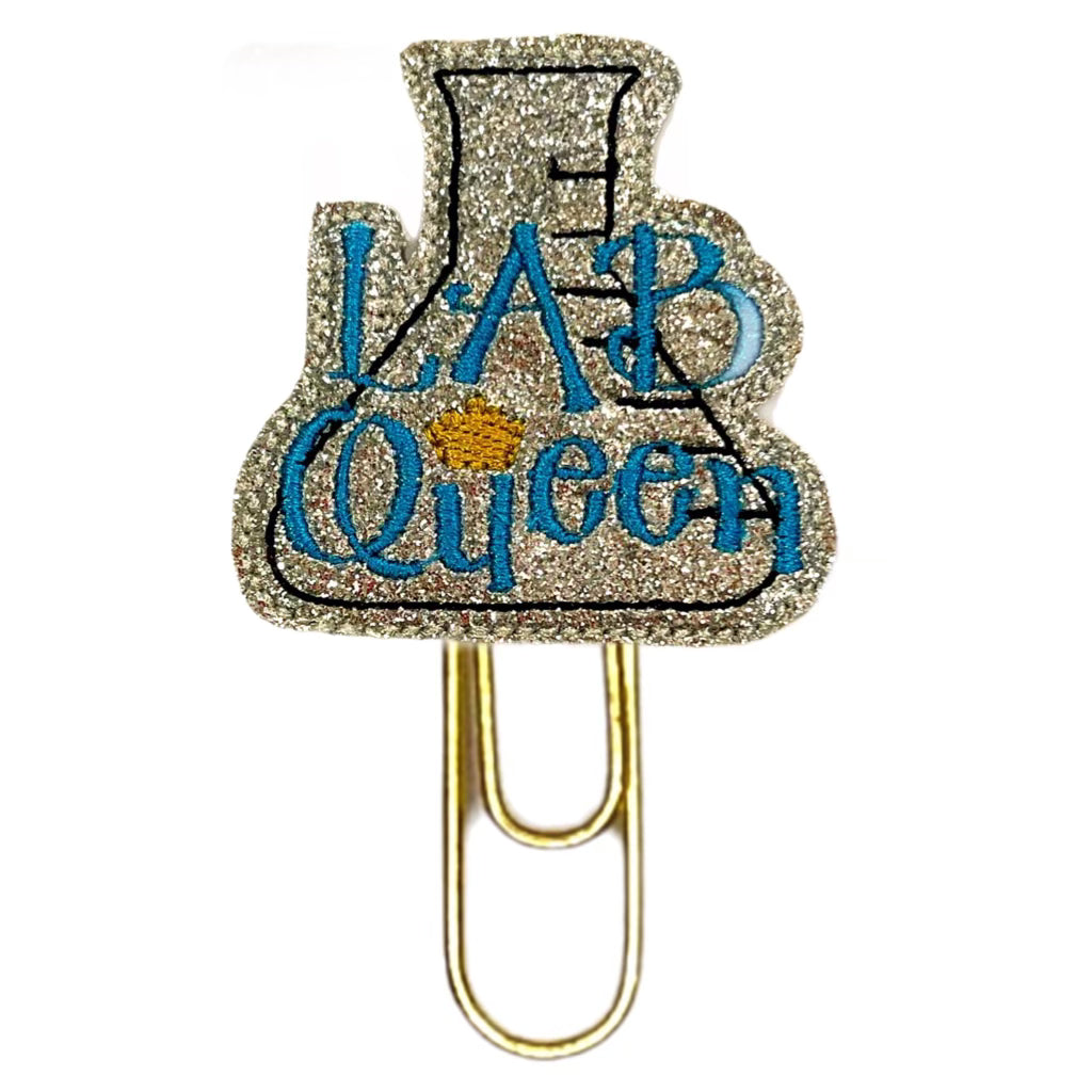 Lab Queen novelty paper clip from Clip Chicks is a shiny silver lab flash with a blue Lab Queen embroidered on it and a paper clip attached to it.