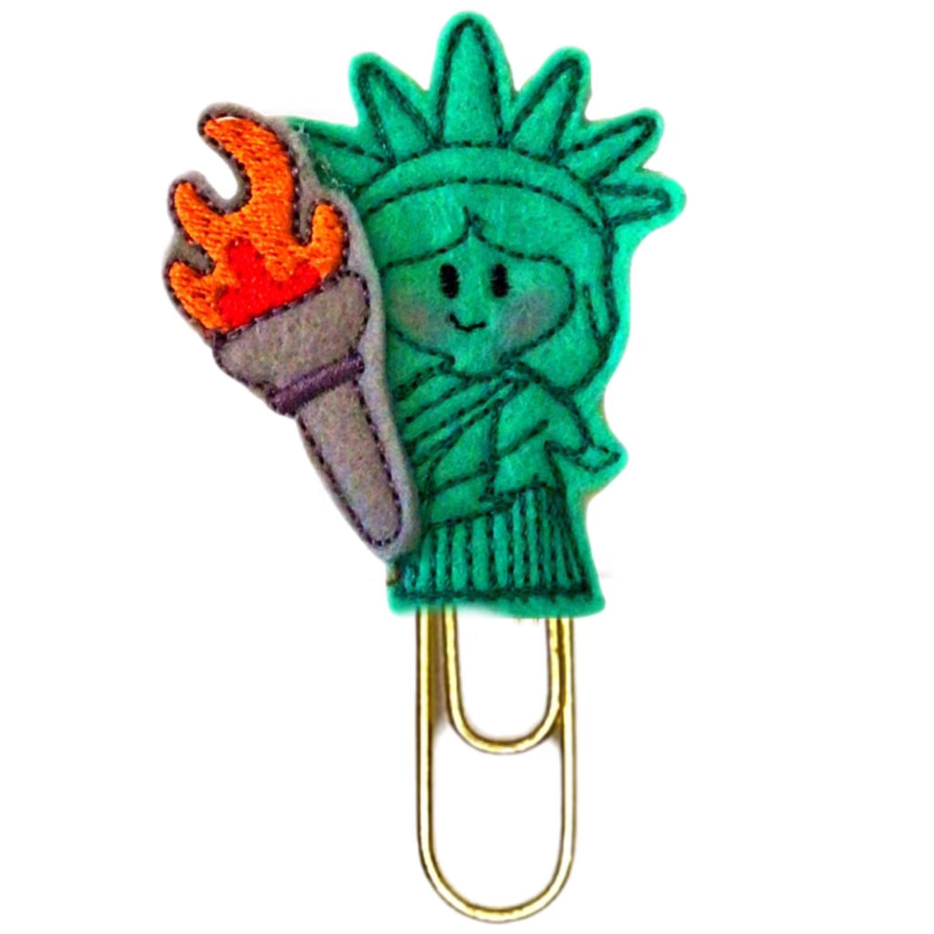 Clip Chicks Lady Liberty novelty paper clip is an adorable mini Statue of Liberty with a large torch in her hand made from felt and embroidery then attached to a gold toned paper clip.