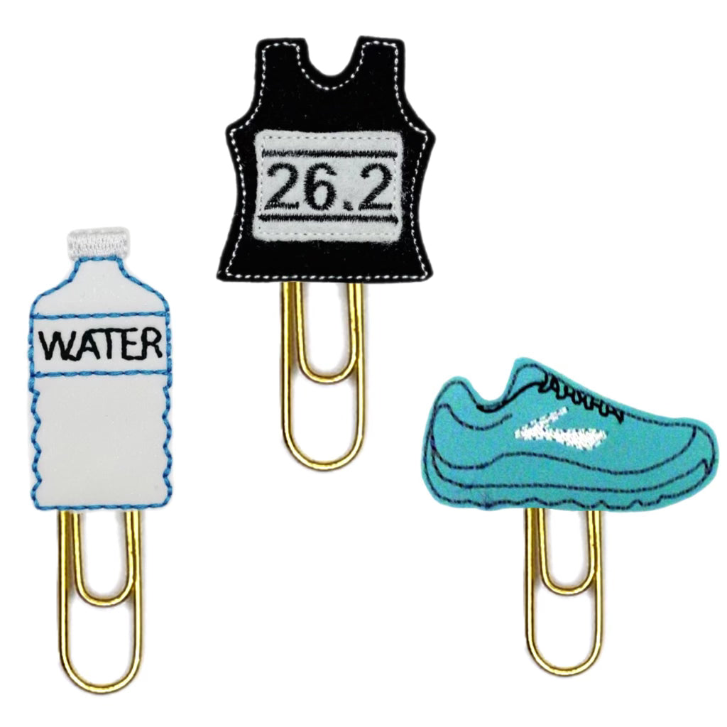 A water bottle, a runner's pinnie and a running shoe novelty paper clips are shown on a white background.