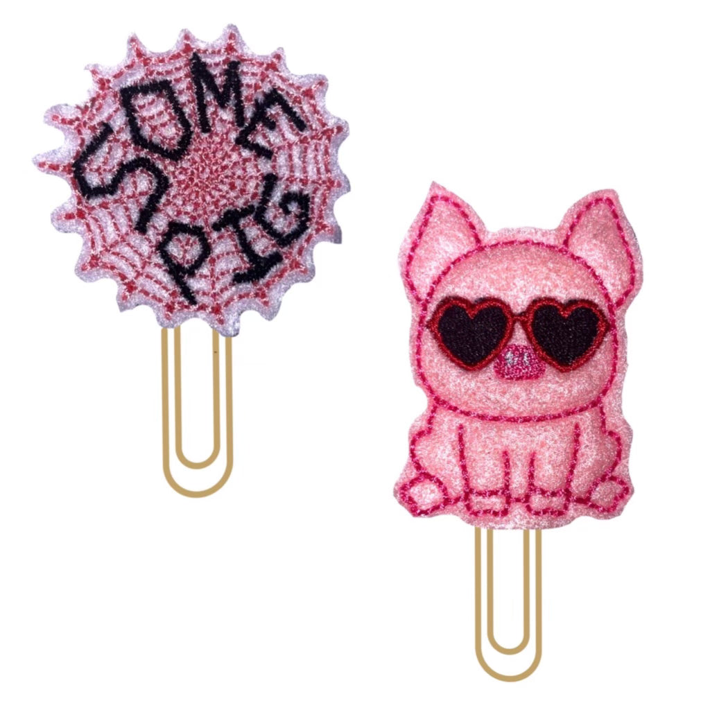 A set of a pig with sunglasses and a spider's web that reads, Some Pig, and shown against a white background.