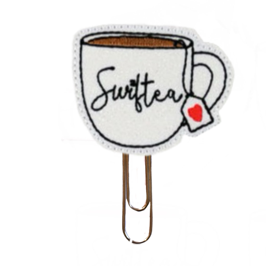 Swiftea novelty paper clip from Clip Chicks is shaped like a cup of tea with a heart on the tea bag label and the word, Swiftea, embroidered on it.